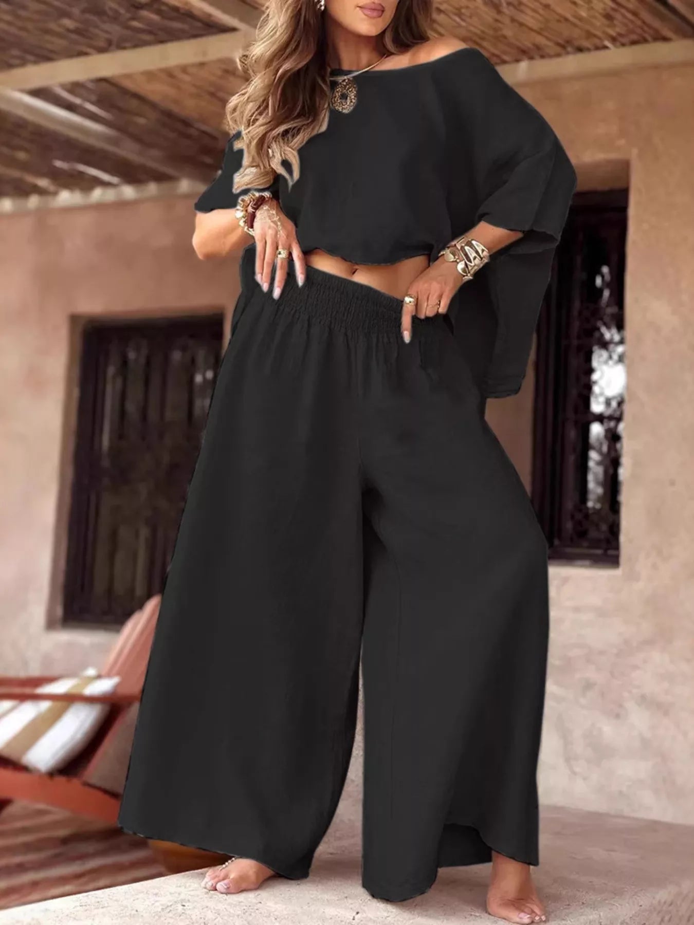 Plus size full size boat neck top with wide leg pants set in black polyester blend