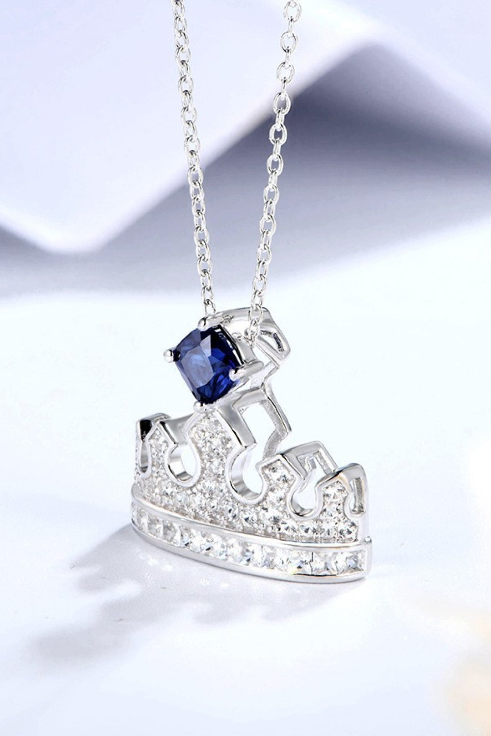 925 sterling silver crown-shaped pendant necklace with lab-grown sapphire and zircon on a delicate chain