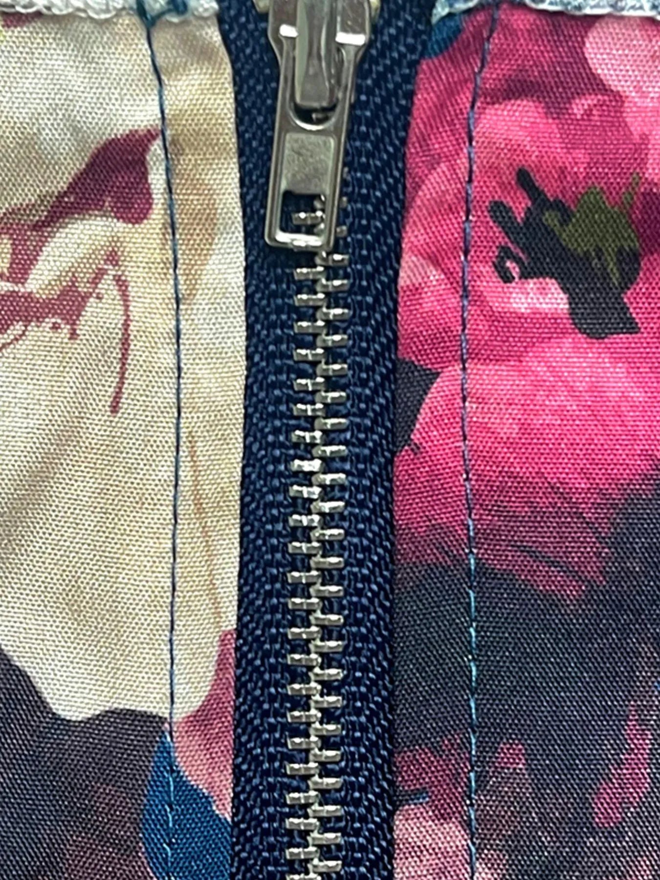 Close-up of zipper on full size floral cami and layered skirt set in pink and cream floral print