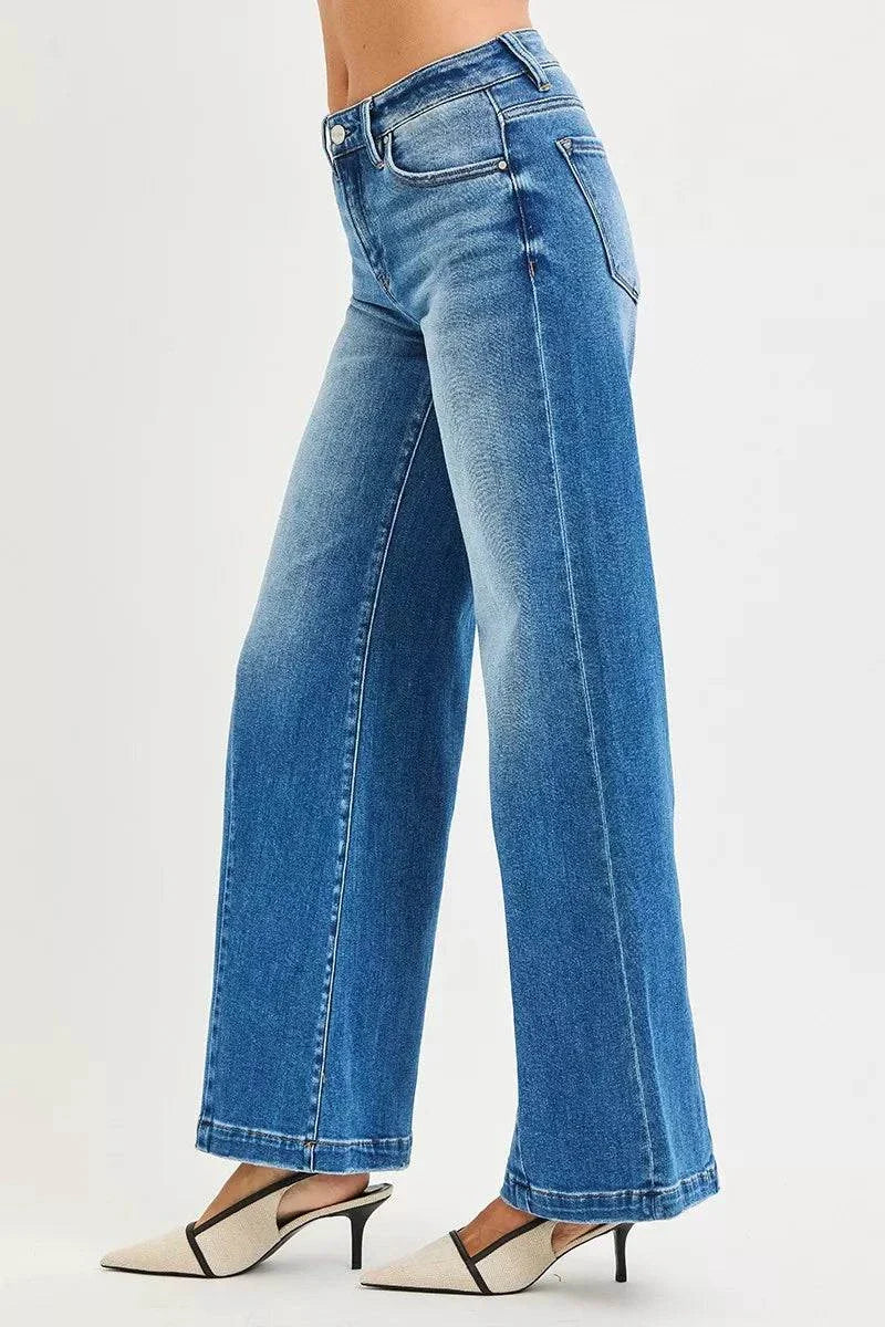 RISEN Full Size Mid Rise Wide Leg Jeans with Flared Look Plus SizeThese Mid Rise Wide Leg Jeans With Flared Look are a statement piece for a retro-inspired outfit. The mid rise waist provides a flattering fit and silhouette. The wiRISEN Full Size