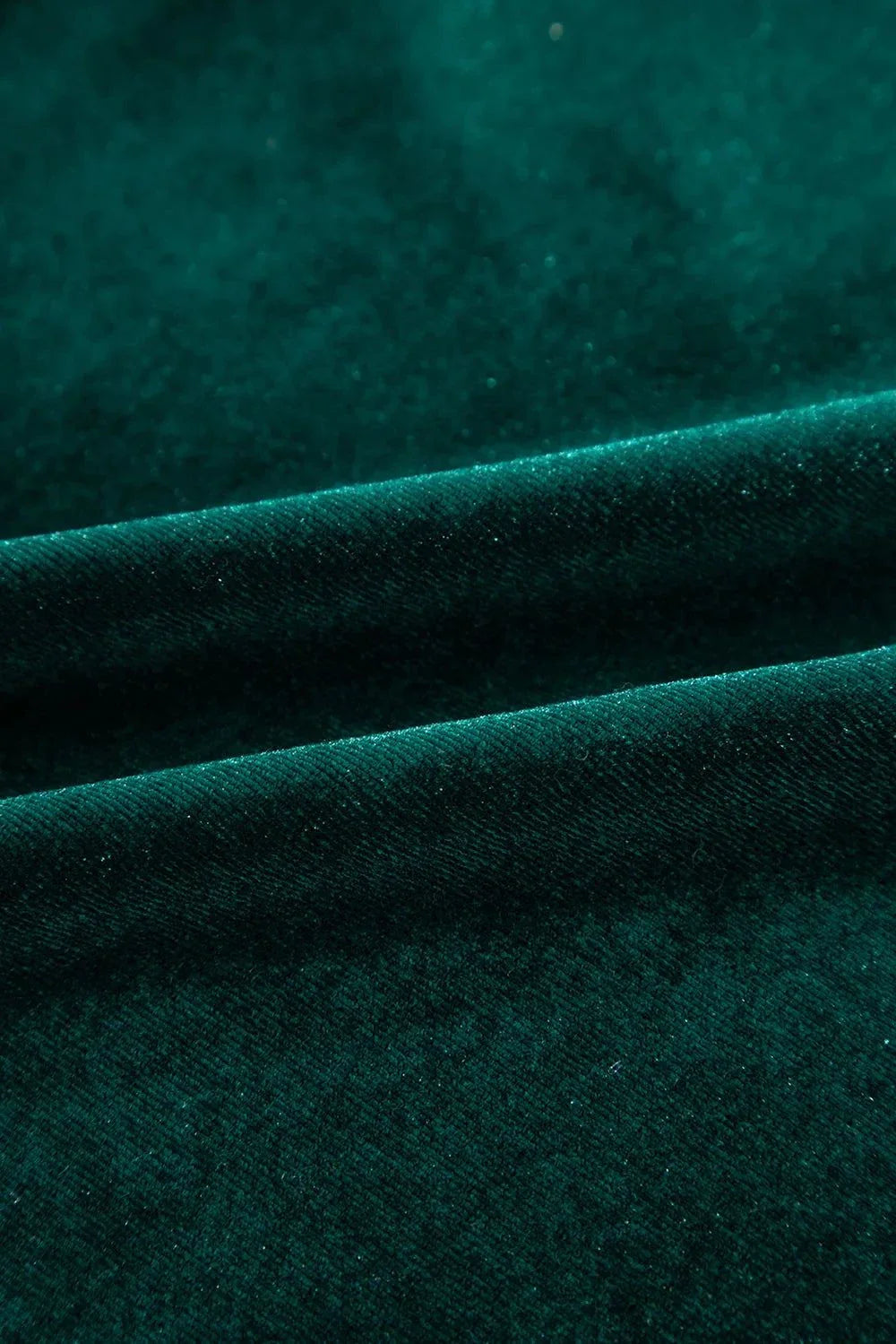 Close-up of green slightly stretchy polyester fabric for Sequin Notched Long Sleeve Blouse