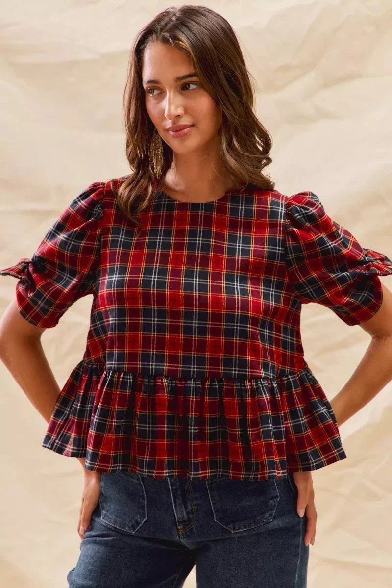 Woman wearing Christmas holiday plaid ribbon short sleeves top with ruffled hem and tied sleeve details