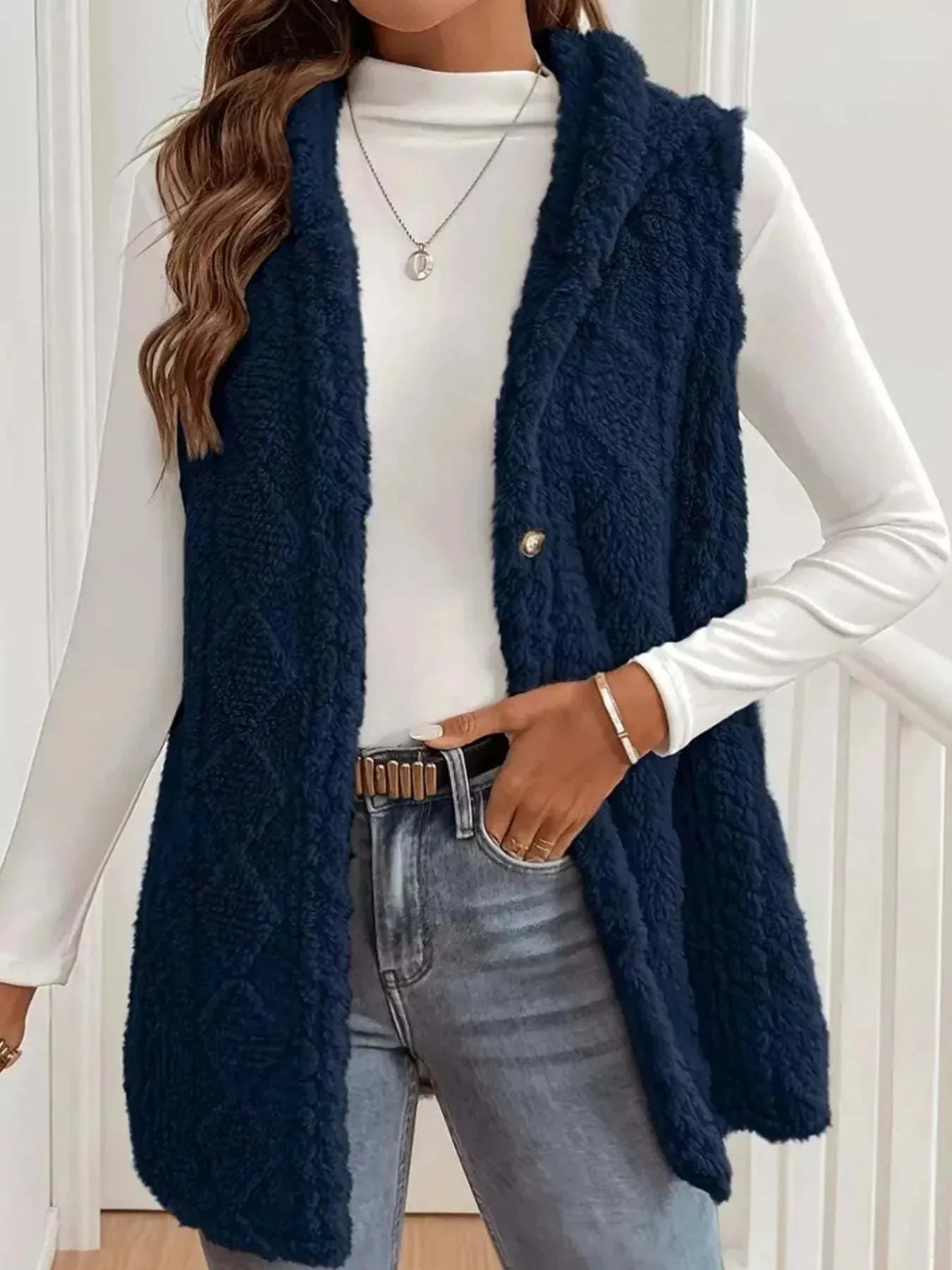 Button Up Plush Hooded Vest in navy blue, buttoned, sleeveless, cozy textured polyester vest with hood, worn over white long sleeve top and jeans