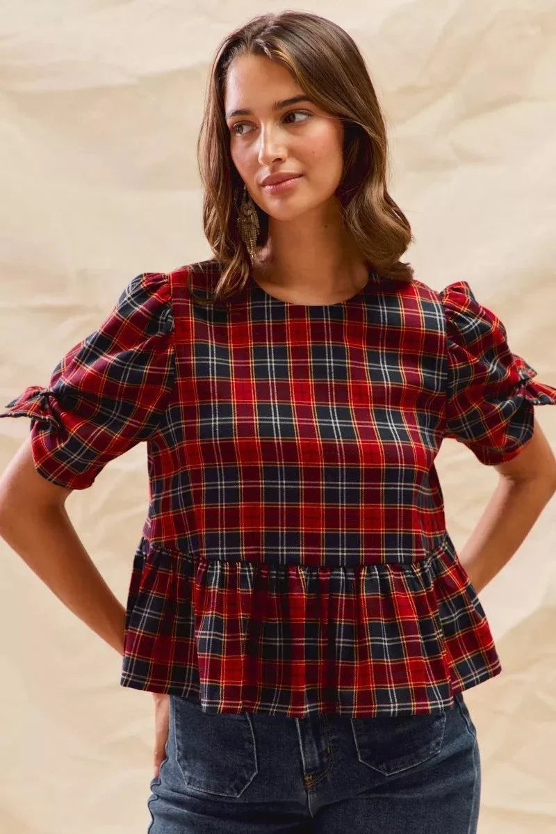Woman wearing Christmas holiday plaid ribbon short sleeves top with ruffled hem and tied sleeves