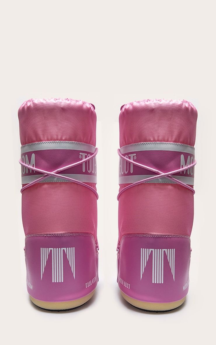 Pair of pink Moon Boot ankle boots with lace-up design and water-repellent shell material