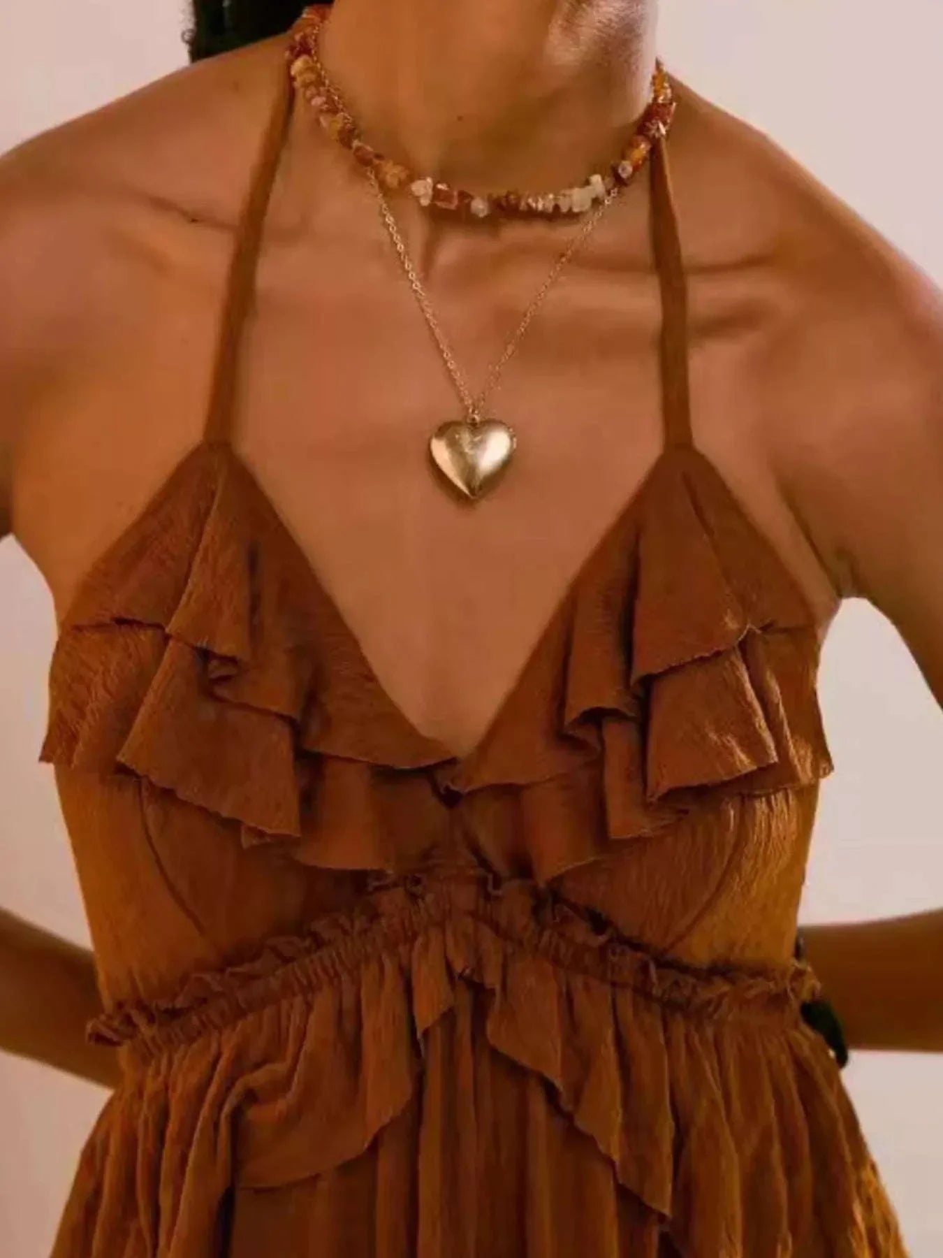 brown ruffled halter neck maxi dress with tied straps and layered detailing