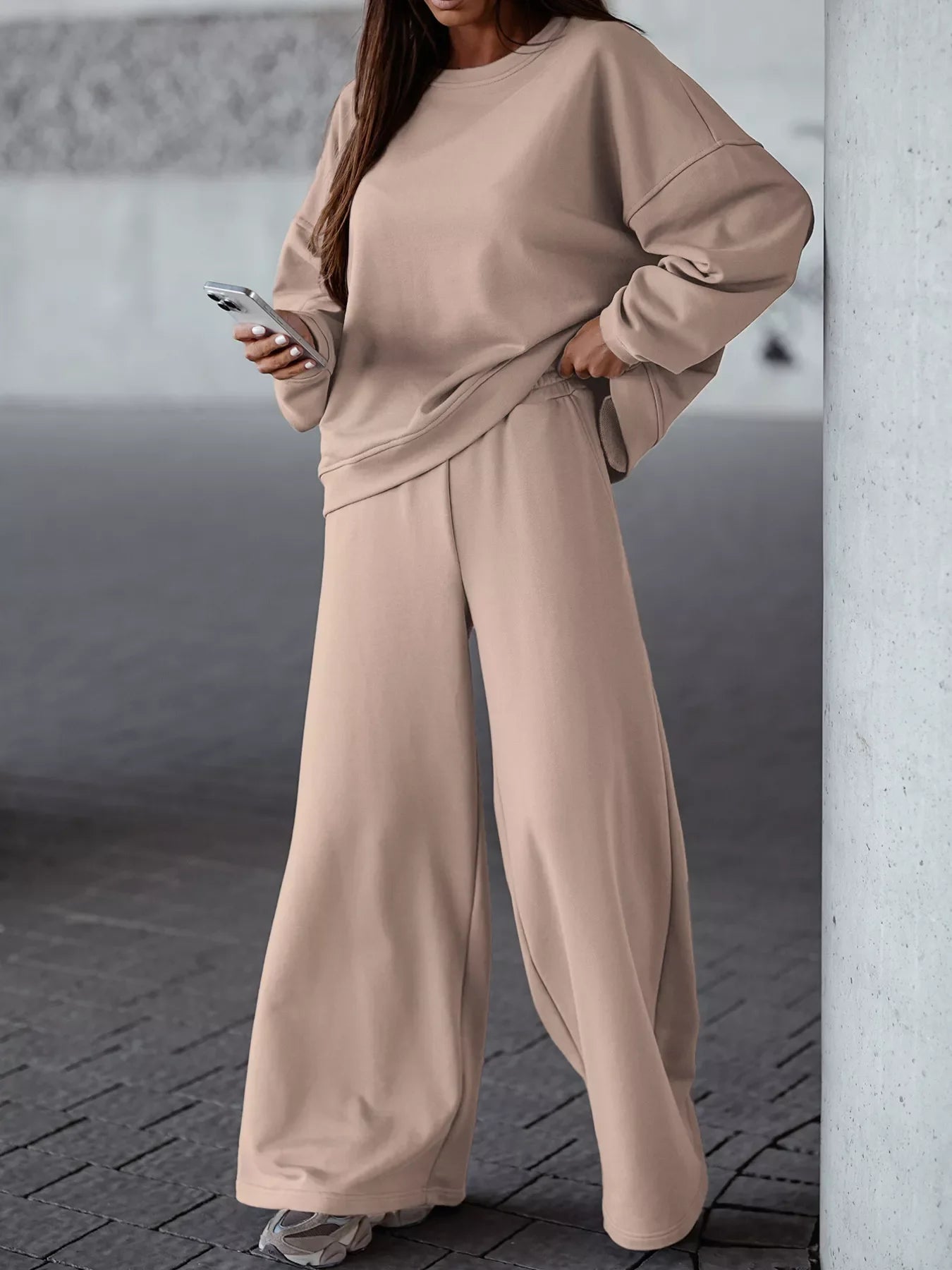 Woman wearing casual loose fit top and wide-leg pants two-piece set in beige with pockets