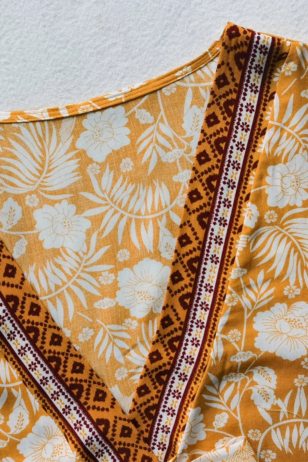 Close-up of printed half sleeve top with yellow floral and geometric patterns from two-piece skirt set