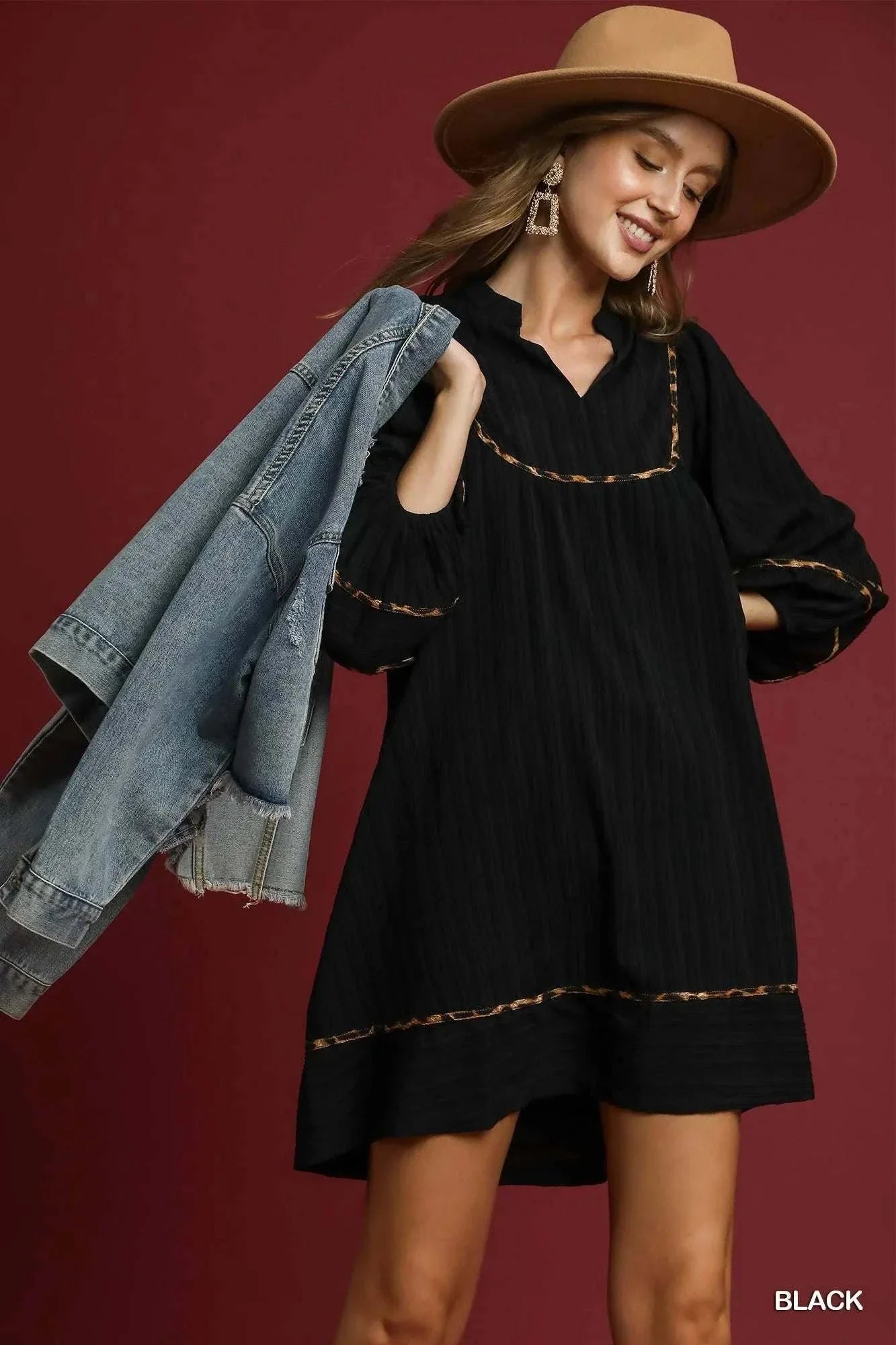 Umgee Plus Size Babydoll Dress in black with leopard trim and textured fabric, styled with a hat and denim jacket