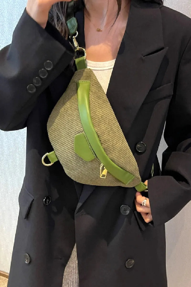 Green corduroy crossbody bag with removable strap worn with black blazer