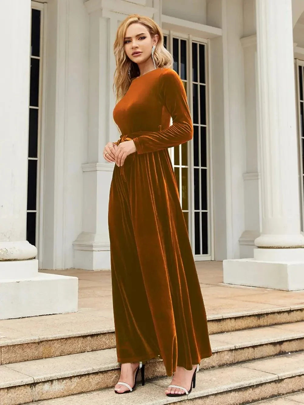 Woman wearing rust-colored tie front long sleeve maxi dress outdoors on steps