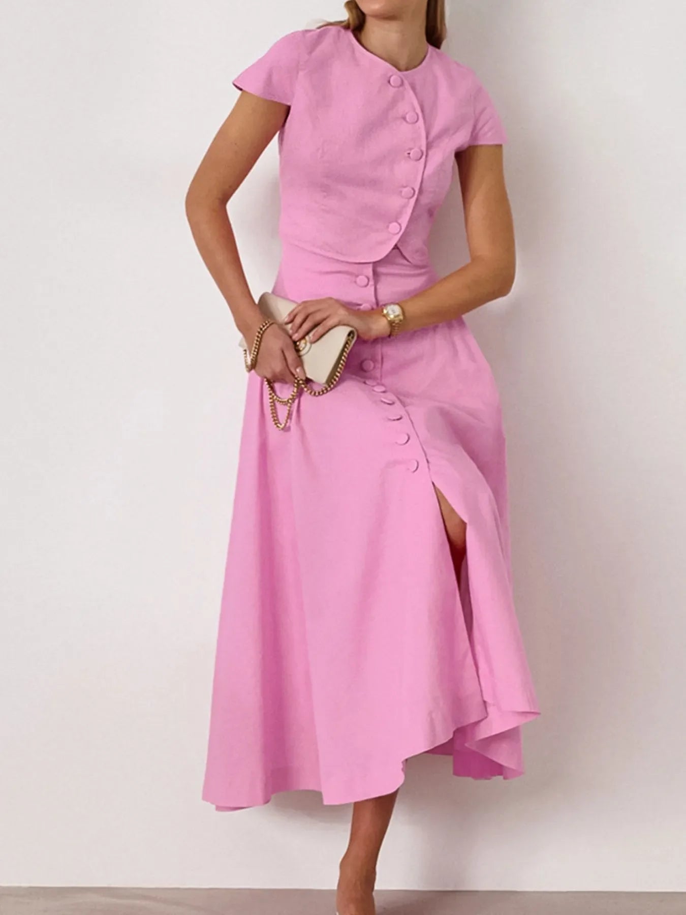 Pink two-piece short sleeve top and skirt set with buttoned design, 100% cotton, no stretch.