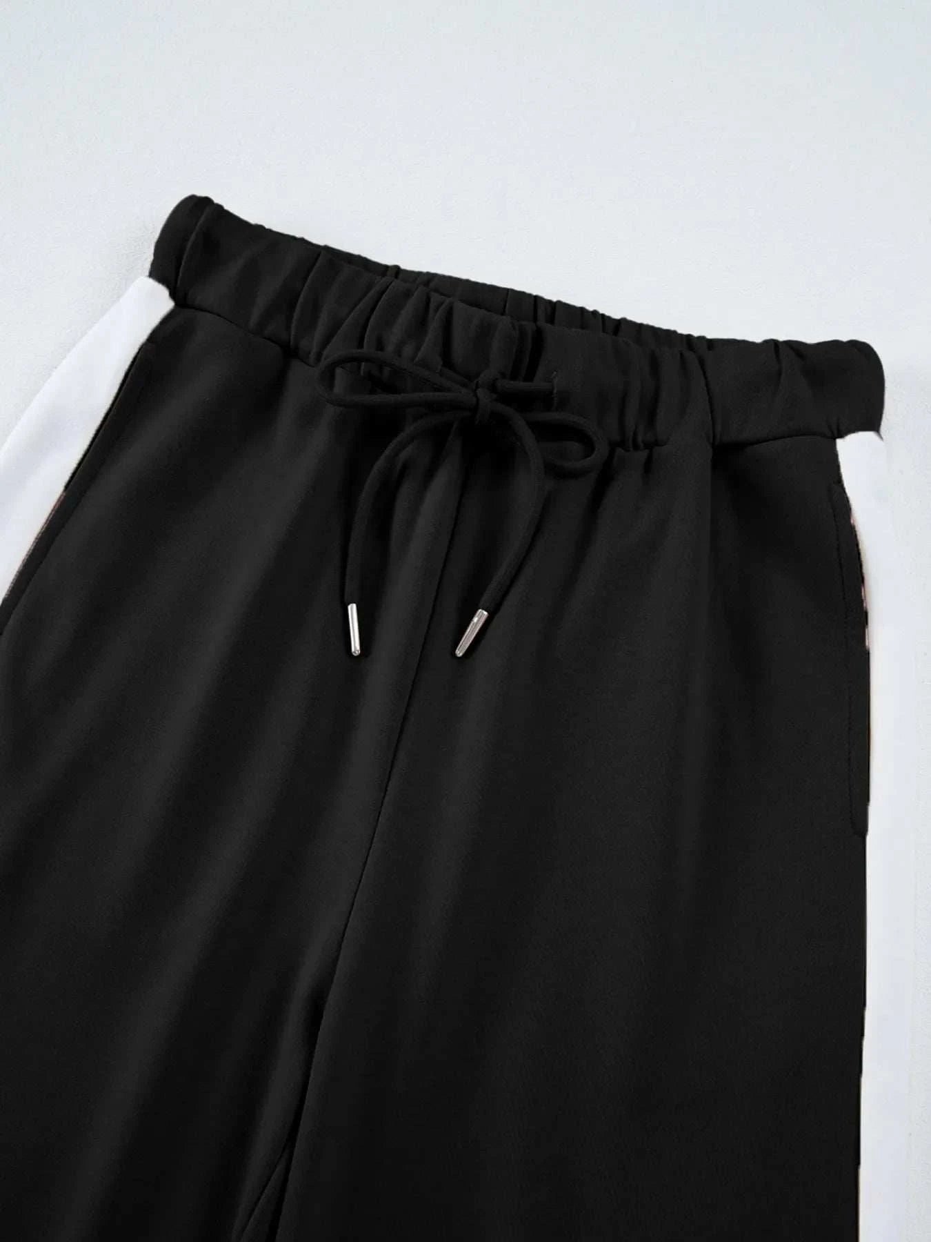 Black pants with white contrast trim and drawstring waistband from two-piece Contrast Trim Round Neck Top set