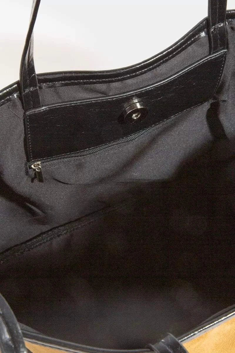 Interior view of Fame Suede Tote with black lining and zippered pocket, faux leather trim shoulder strap visible