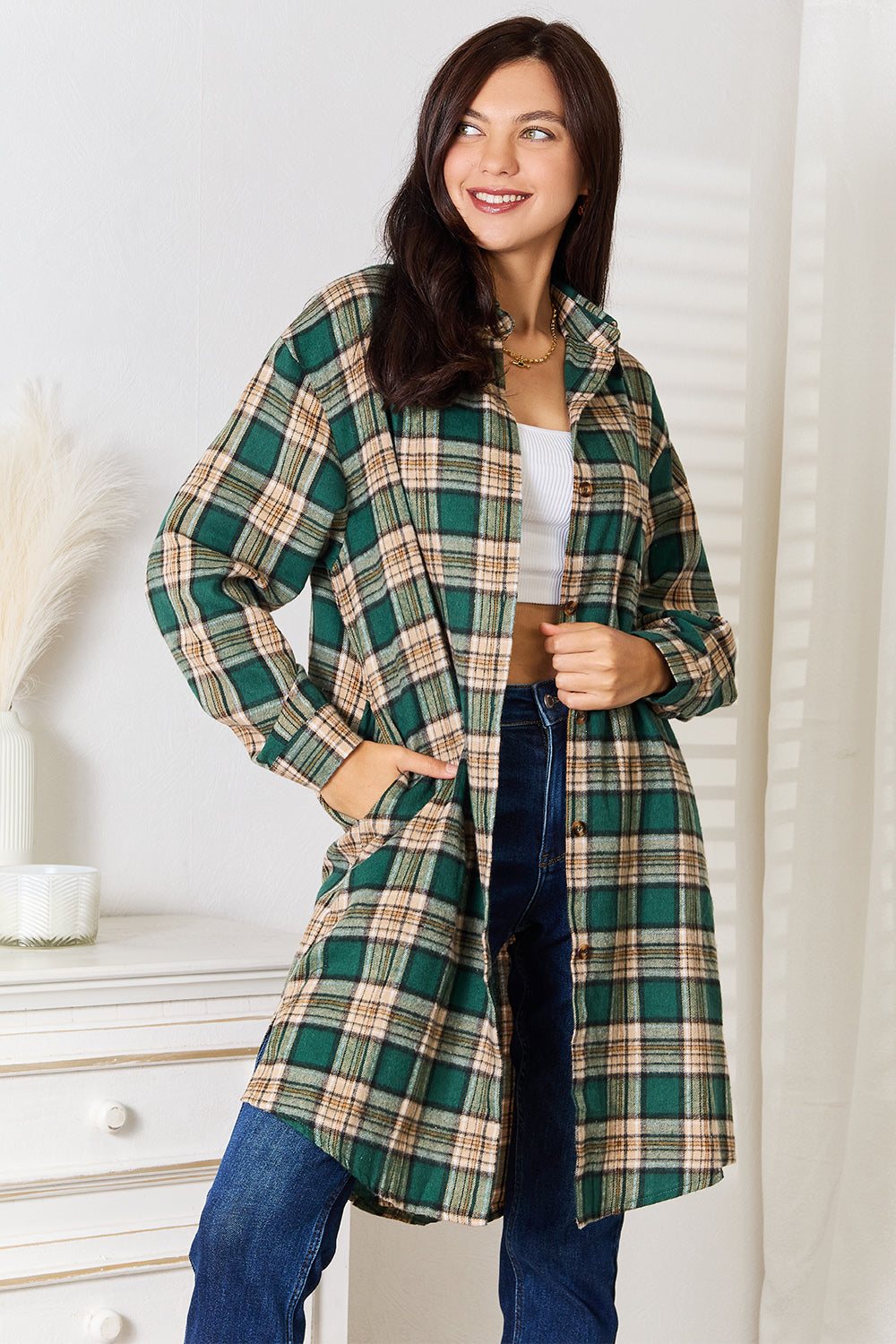 Woman wearing Mandy Plaid Collared Neck long sleeve shirt with green and beige plaid pattern and blue jeans