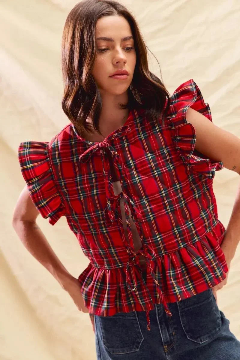 Woman wearing Christmas holiday plaid ruffled quilt vest top with tied front and layered ruffle details