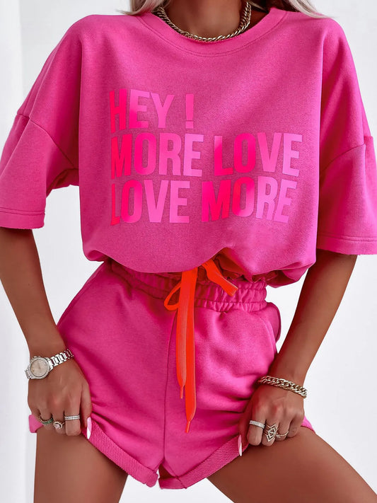 Pink letter graphic top and shorts set with drawstring waist, slightly stretchy polyester material, casual two-piece outfit