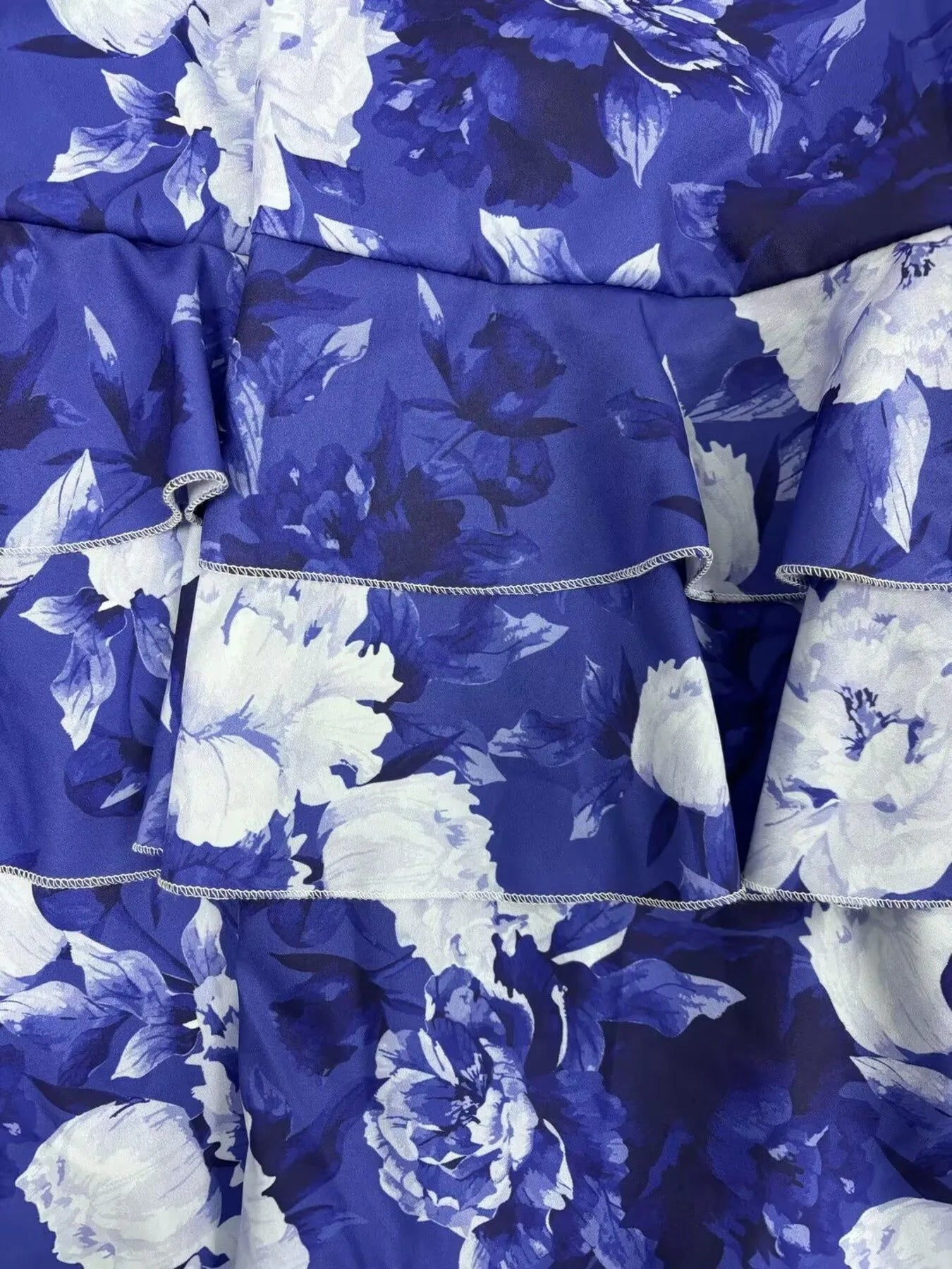 close-up of full size floral cami and layered ruffled skirt set in blue with white flower print
