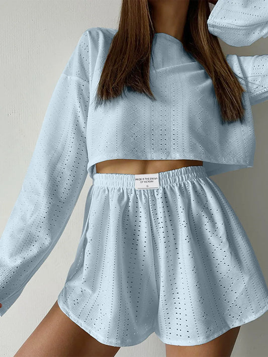 Light blue eyelet round neck top and shorts set with long sleeves and elastic waistband, made of slightly stretchy polyester blend.