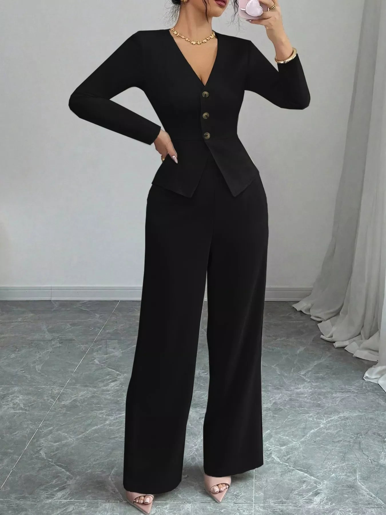 Black button up long sleeve top and pants set with a fitted silhouette and wide-leg pants