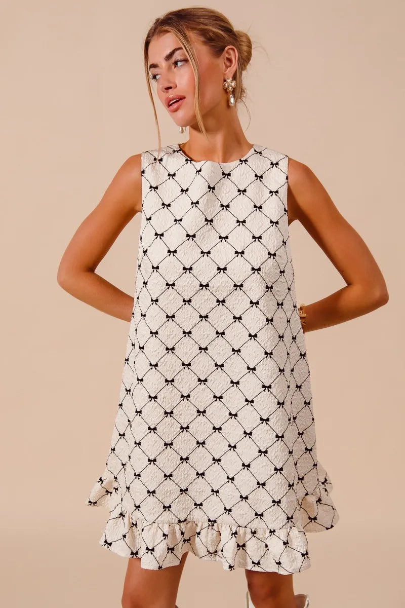 SO ME Texture Bow sleeveless mini dress with black and white bow print and ruffle hem