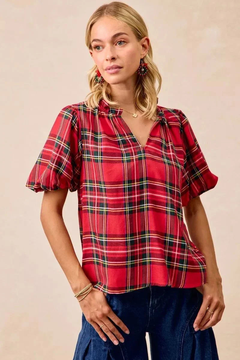 BiBi Christmas Plaid Short Sleeves Ruffled BlouseThis Christmas plaid short sleeves ruffled blouse is a festive and charming addition to your holiday wardrobe. The classic plaid pattern evokes a cheerful and cozy hChristmas plaid blouse
