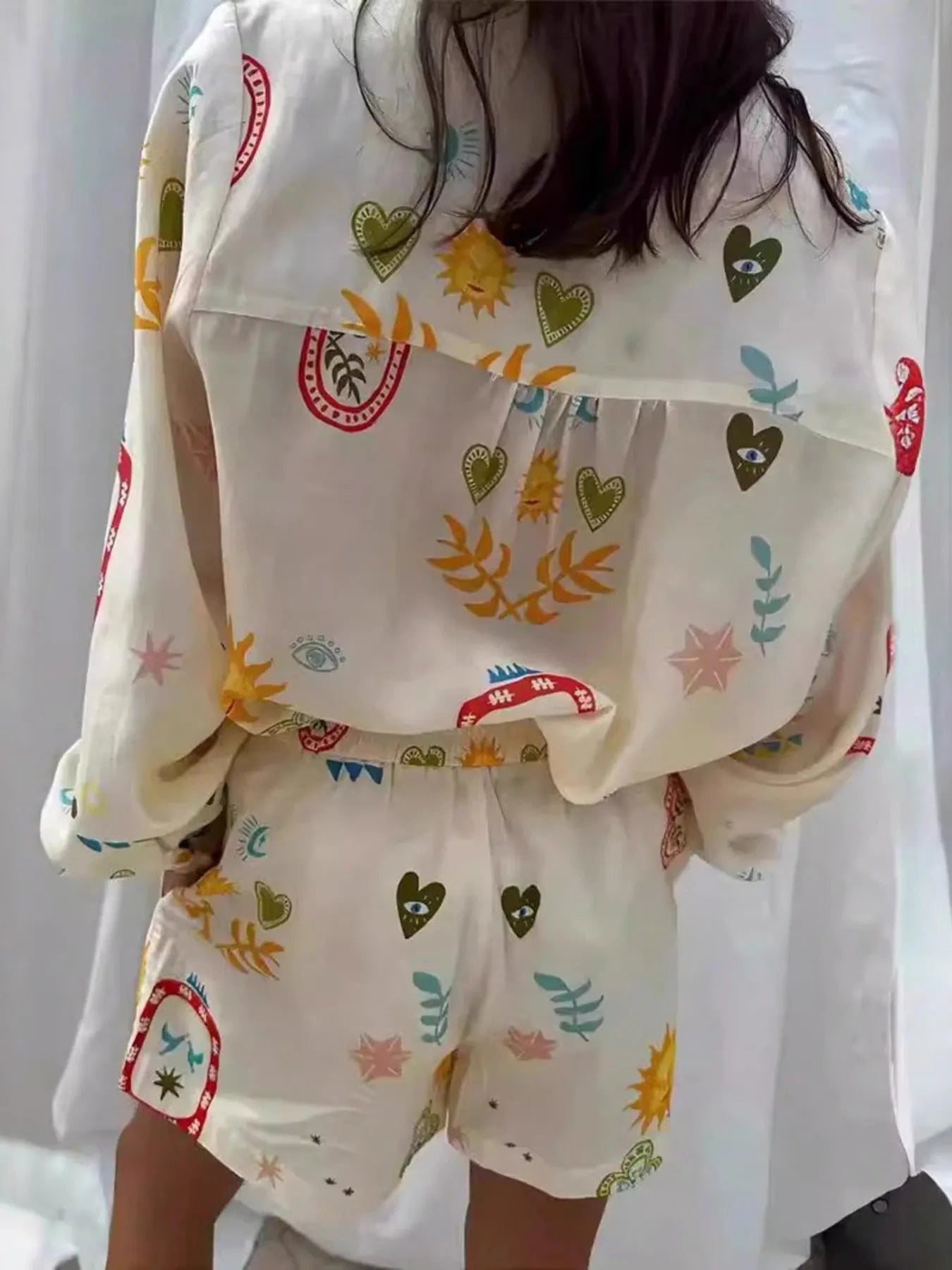 Button up long sleeve shirt and shorts set with colorful heart and sun patterns on white fabric