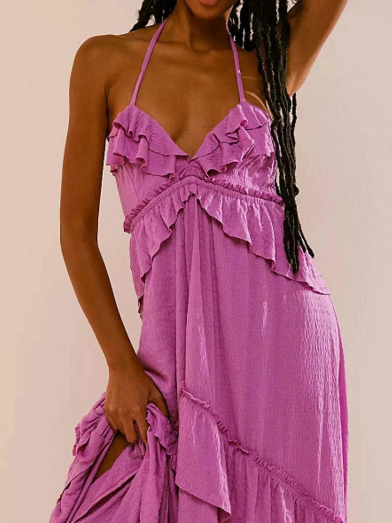 woman wearing purple ruffled halter neck maxi dress with tied straps