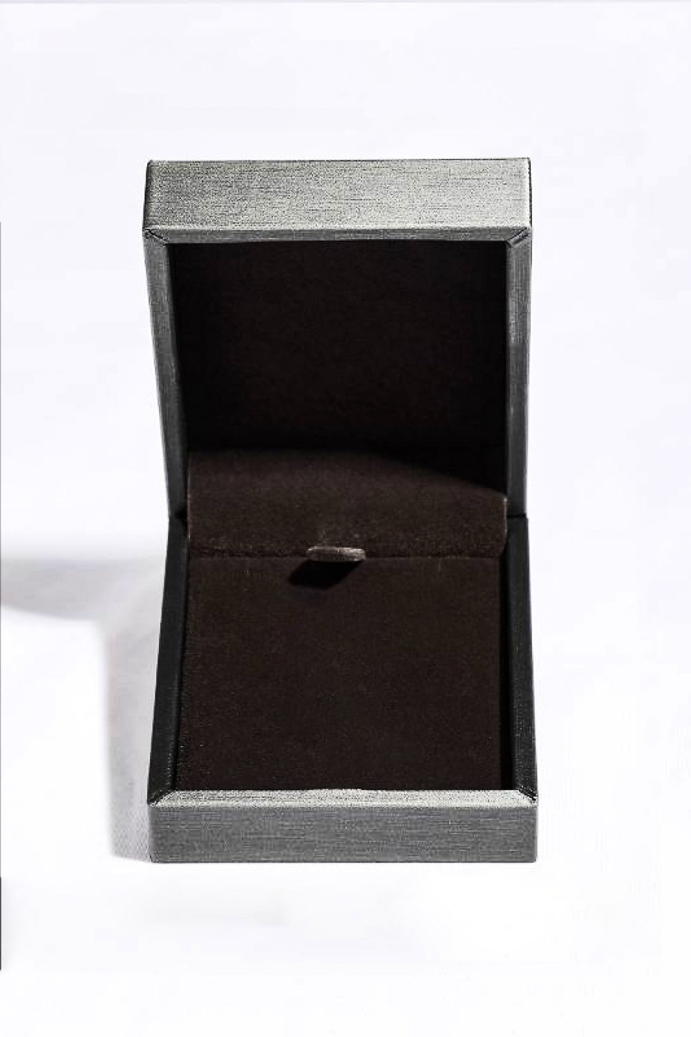 Empty gray jewelry box with black velvet interior for lab-grown sapphire pendant necklace