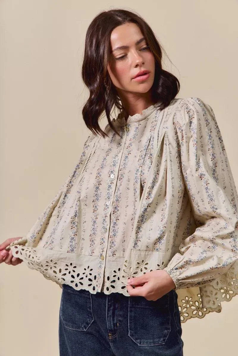 woman wearing floral print lace button-down shirt with eyelet and ruffled details