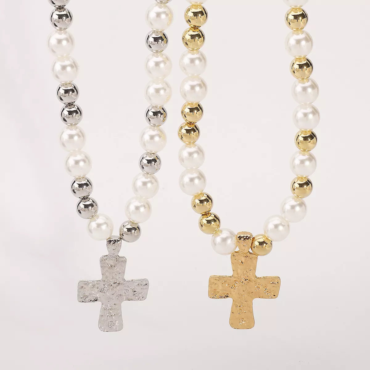 Pearl and cross pendant necklaces with 18K gold-plated and silver accents on synthetic pearl chains