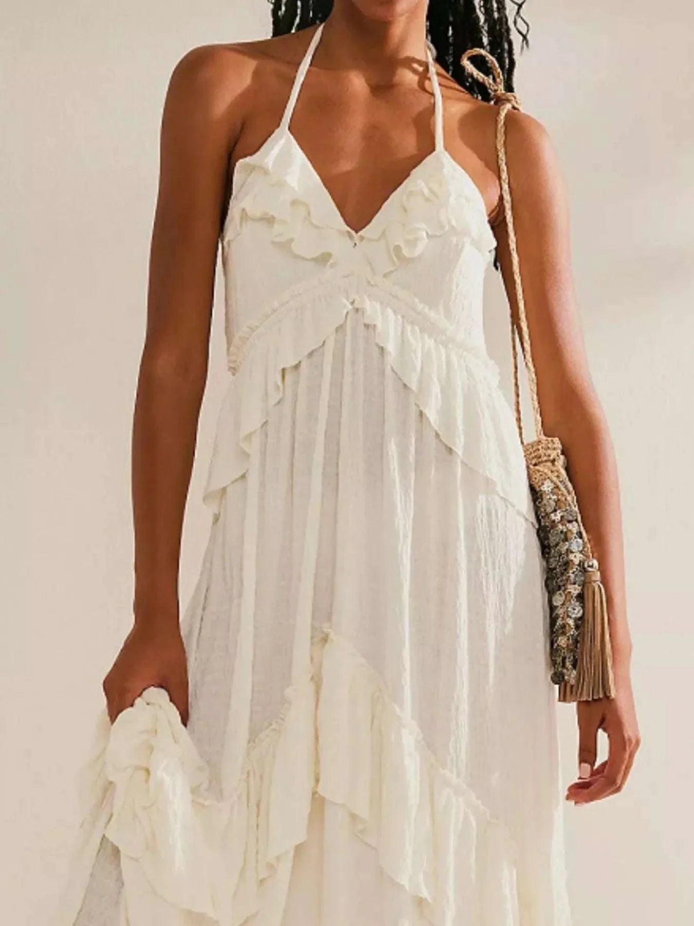 White ruffled halter neck maxi dress with tied straps and 100% polyester fabric