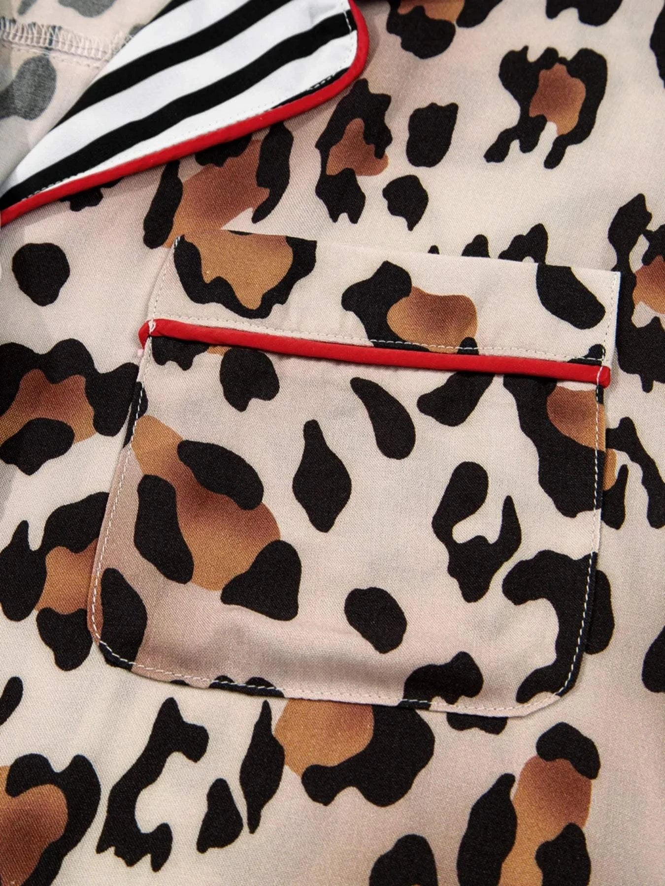 Leopard print shirt pocket with striped trim and red piping close-up