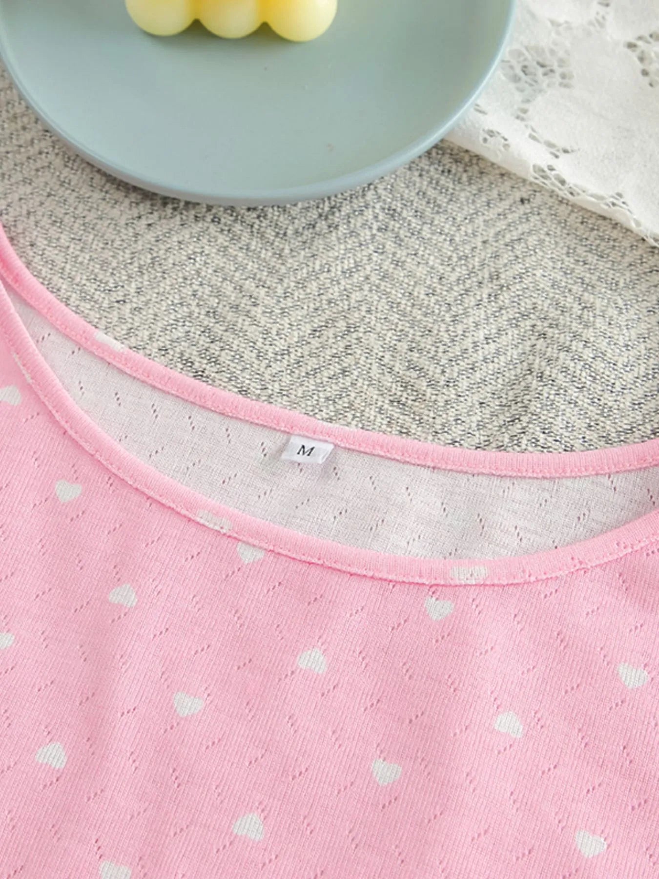 Pink polka dot round neck top with ruffled detail from two-piece lounge set