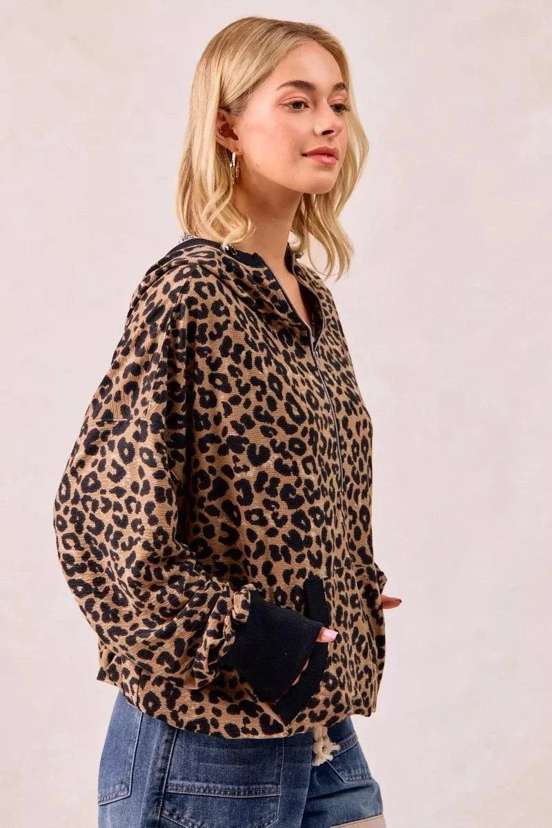 woman wearing leopard print waffle half zip up hoodie with pocket and jeans