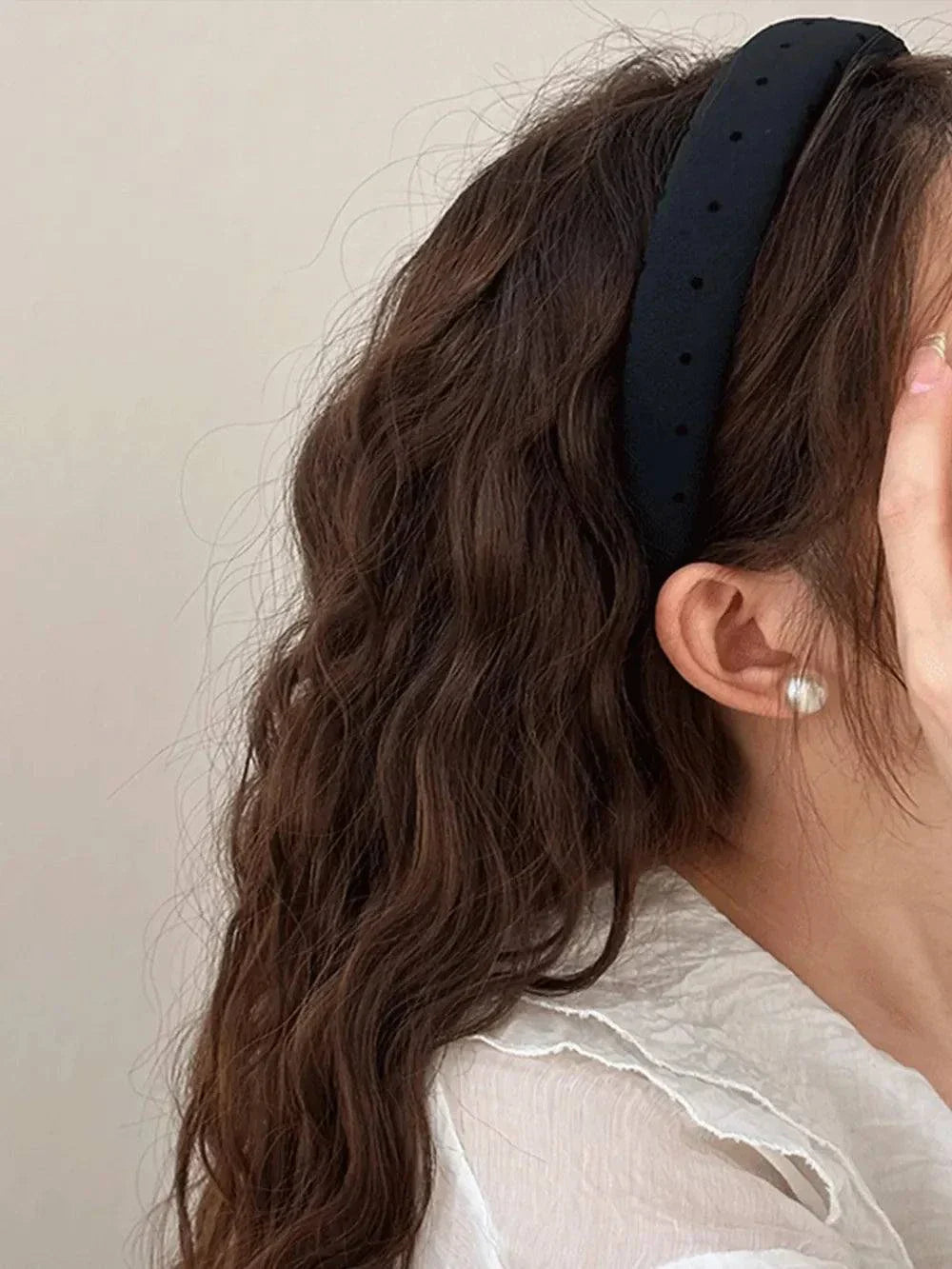 Polka dot polyester wide headband on woman with wavy hair and pearl earring