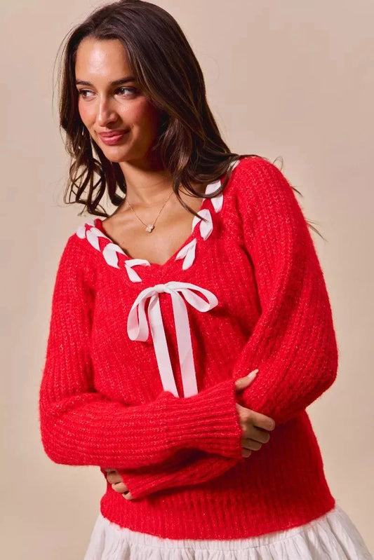 Red V-neck sweater with satin tape braided ribbon tie detail on the neckline