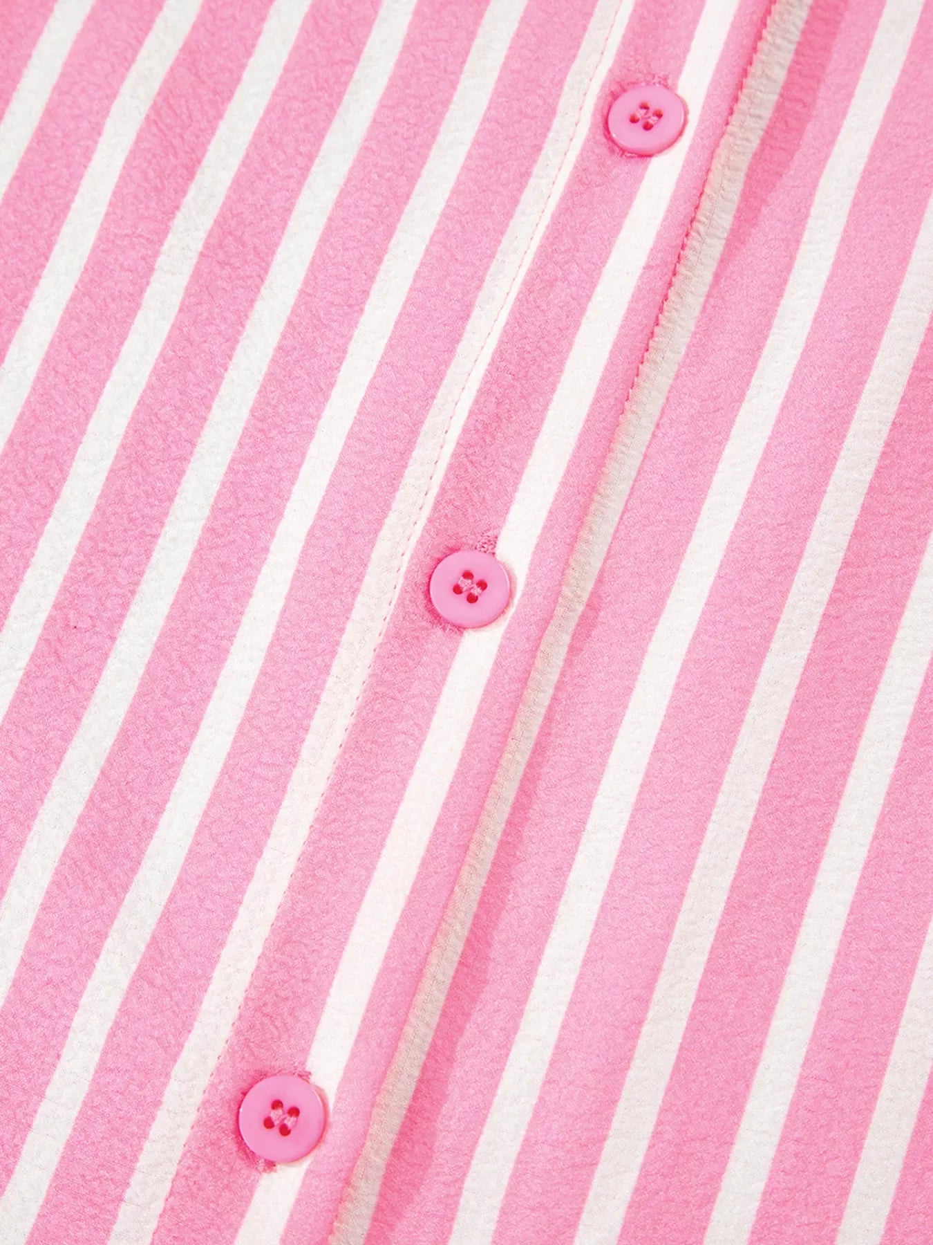 Close-up of pink and white stripe buttoned front fabric from two-piece sleepwear set