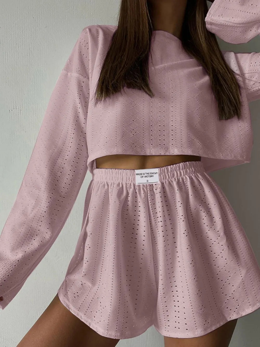 Pink eyelet round neck top and shorts set with slight stretch, made of polyester and elastane