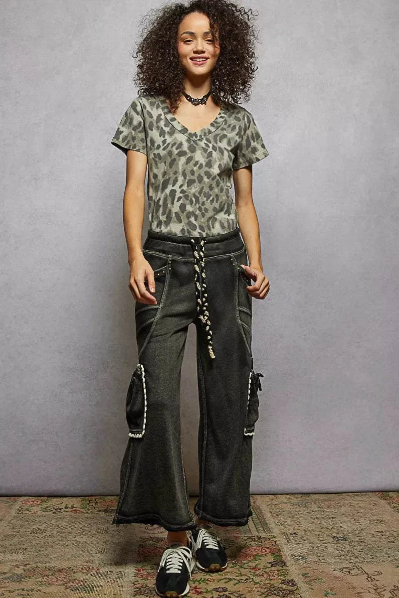 Woman wearing POL printed V-neck short sleeve t-shirt with leopard print and casual pants