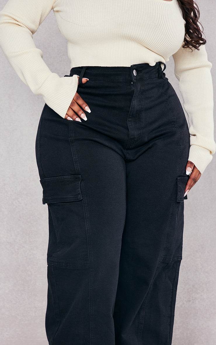 Plus Black Cargo Wide Leg JeansReimagine utilitarian style with these black, wide-leg cargo jeans. Cut from durable denim, these jeans offer a contemporary take on a classic silhouette. The multipRedemption By Ashley NorthPlus Black Cargo