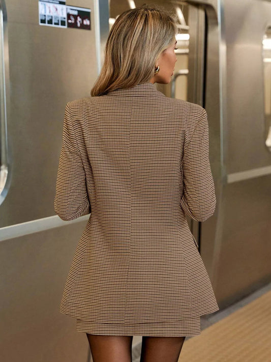 woman wearing single-breasted plaid blazer and skirt set standing in subway station