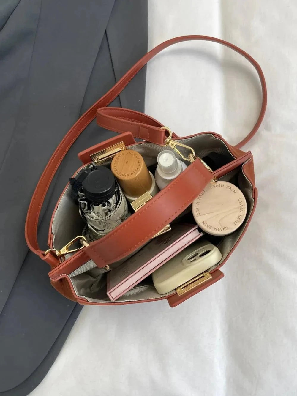 Solid Color Handbag with Removable Strap for Versatile Styling.