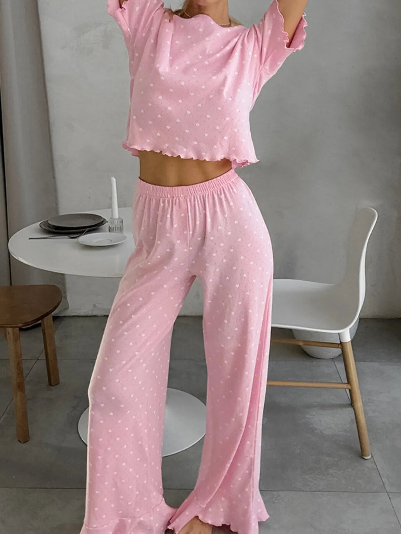 Pink polka dot round neck top and pants lounge set with ruffled edges and slight stretch