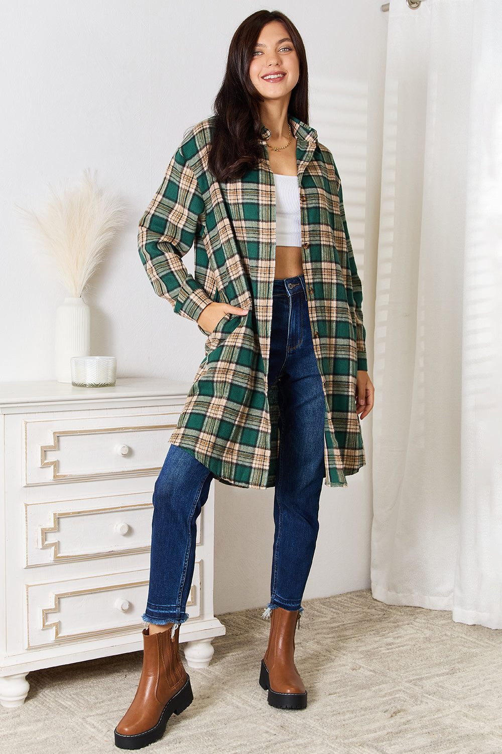 Woman wearing Mandy plaid collared neck long sleeve shirt with jeans and brown boots indoors