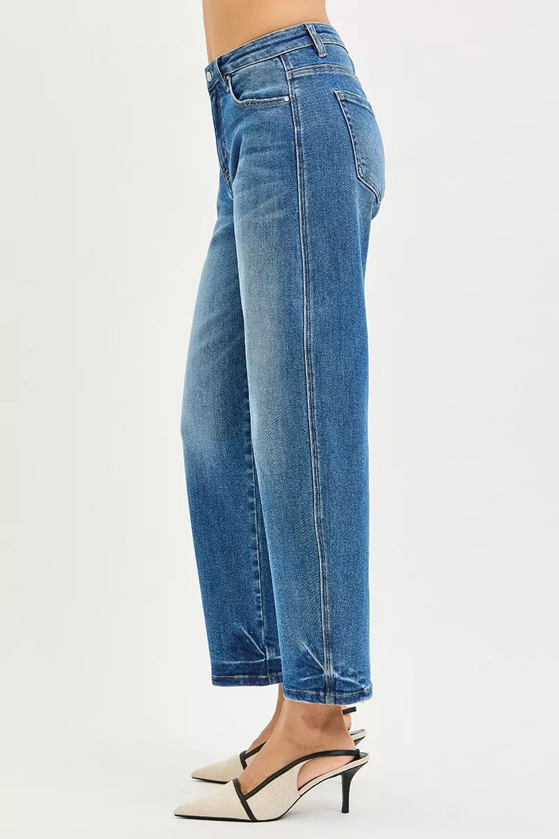 Side view of RISEN Slouchy Cropped Barrel Jeans in blue denim worn with heels