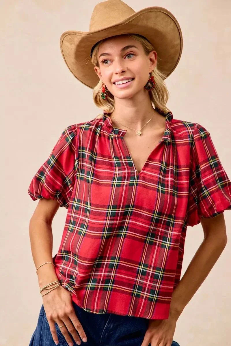 BiBi Christmas Plaid Short Sleeves Ruffled BlouseThis Christmas plaid short sleeves ruffled blouse is a festive and charming addition to your holiday wardrobe. The classic plaid pattern evokes a cheerful and cozy hChristmas plaid blouse
