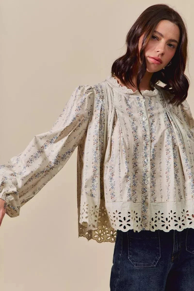 Woman wearing SO ME floral print lace button-down shirt with ruffled eyelet lace details and long sleeves