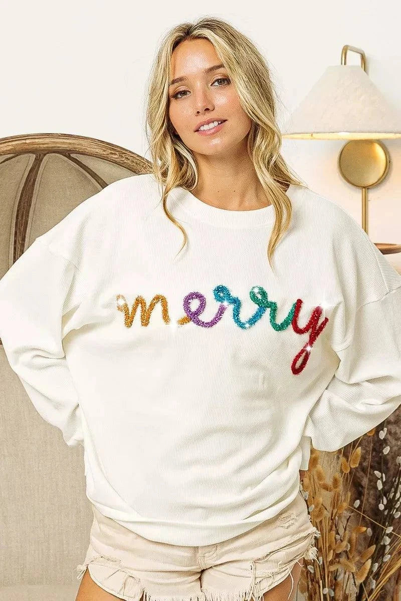 White sweatshirt with colorful Merry Tinsel Lettering and drop shoulder design