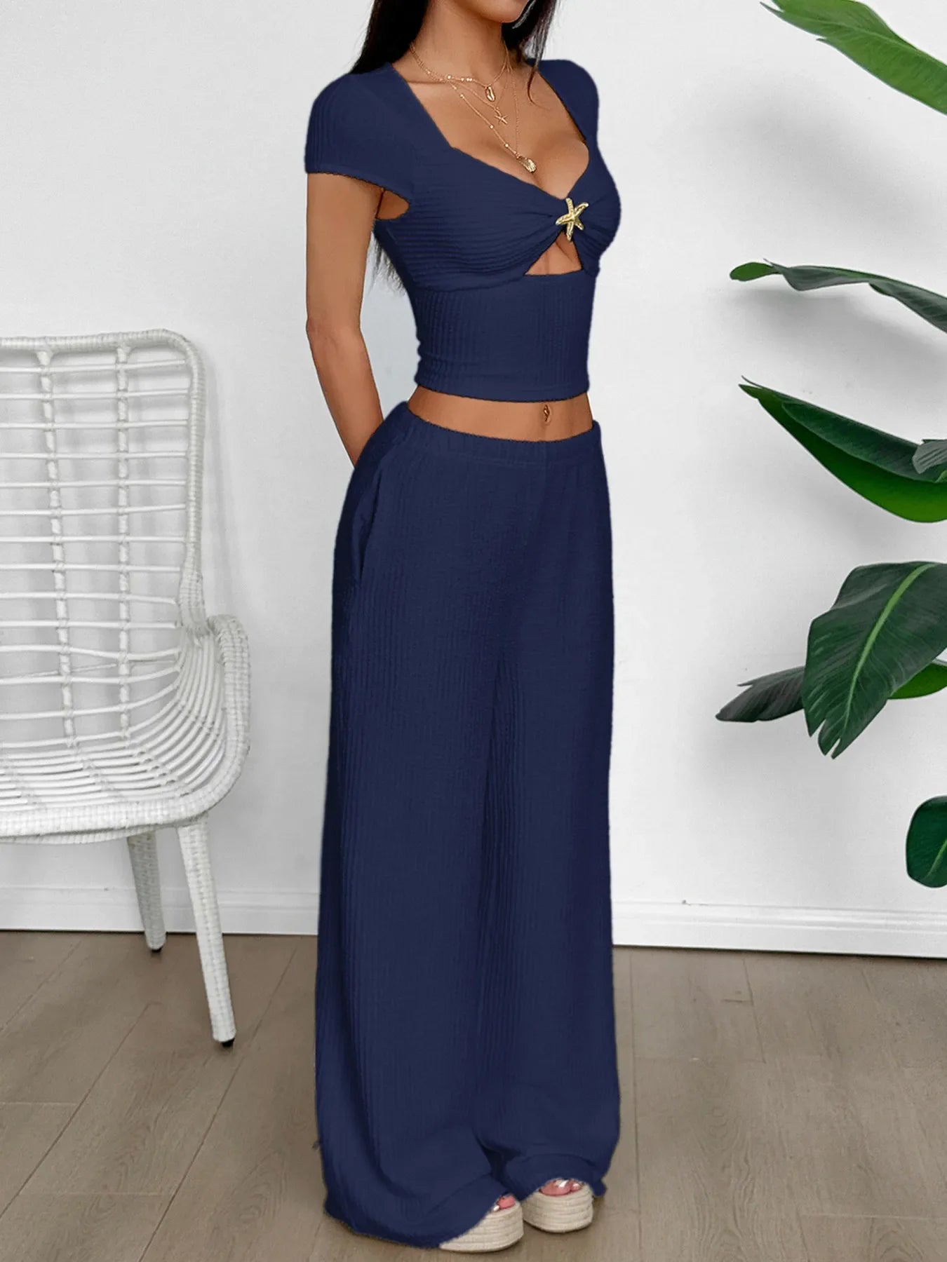 Navy blue cutout short sleeve top with tied and crisscross design paired with matching wide-leg pants set